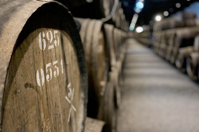 Wine Tasting with Tapas Walking Tour in Porto - Stop 2: Ribeira do Porto cobblestones and riverfront stories